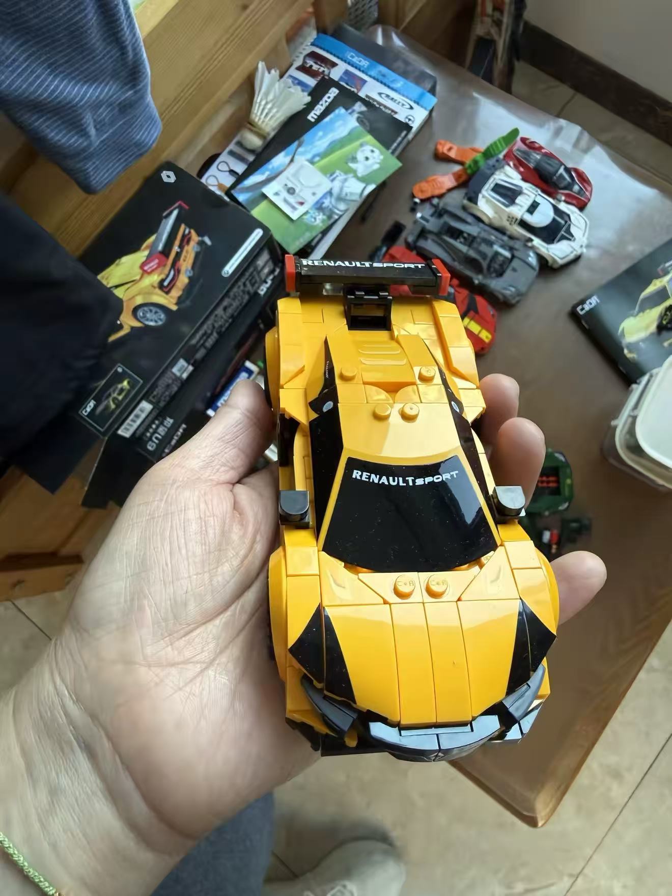 Customer holding yellow brick car